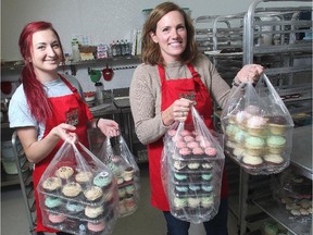 Jodi Willoughby, co-owner of the Crave cupcakes stores, right, along with staff member Laura Langille, put cupcakes on shelves at the Willow Park outlet Friday December 5, 2014. The day's unsold products are collected by the Calgary Food Bank.