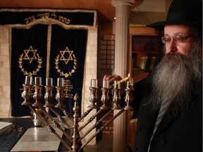 Rabbi Menachem Matusof lights the first candle on a menorah at Chabad Lubavitch of Alberta on December 9, 2014. The annual menorah lighting at City Hall for the start of Hanukkah 2014 will happen on the evening of Tuesday, December 16.