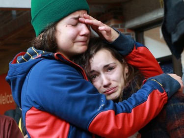 Students at the Alberta College of Art and Design (ACAD) hug each other for support during an emotional vigil in memory of fellow student Zackariah Rathwell who was one of the victims in Calgary's worst mass murder. Five young people were stabbed to death at a house party in Brentwood in April