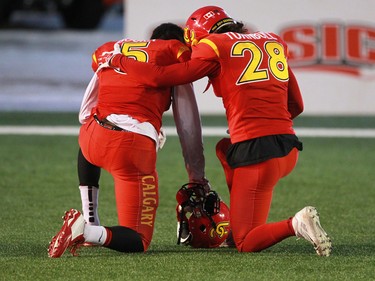 Calgary Dinos Elie Bouka, left and Hunter Turnbull console each other after losing the 2014 Canada West Hardy Cup to the Manitoba Bisons. The powerhouse team had one the cup six straight years.