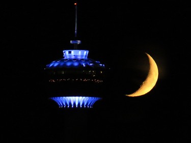The crescent moon sets behind the Calgary Tower showing off its new LED lighting on Sunday evening September 28, 2014