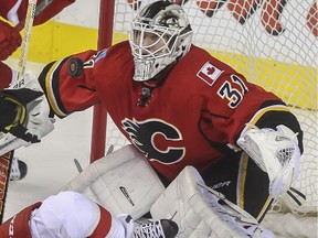 Calgary Flames goalie Karri Ramo keeps an eye on the puck during game action against the detroit Red Wings at the Saddledome in Calgary, on January 7, 2015.