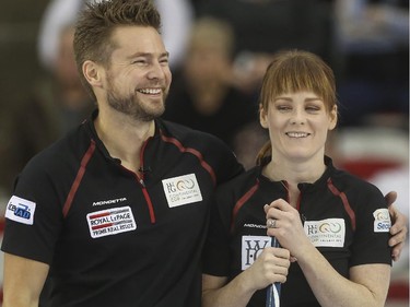 Mike McEwen puts his arm around his wife and mixed doubles partner Dawn McEwen after a good play during mixed doubles Continental Cup action at the Markin MacPhail Centre in Calgary, on January 10, 2015. Team Europe overtook them in this 6-5 nail-biter match.