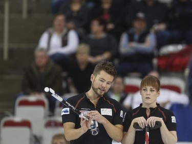 Couple curlers Mike and Dawn McEwen discuss strategy during mixed doubles Continental Cup action at the Markin MacPhail Centre in Calgary, on January 10, 2015. Team Europe overtook them in this 6-5 nail-biter match.