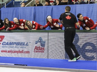 John Morris high fives the Team Canada spectators after winning mixed doubles with Kaitlyn Lawes against Team Europe's David Murdoch and Eve Muirhead at the Continental Cup at the Markin MacPhail Centre in Calgary, on January 10, 2015. The final score was 8-5.