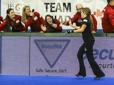 Kaitlyn Lawes high fives the Team Canada spectators after winning mixed doubles with John Morris against Europe's David Murdoch and Eve Muirhead at the Continental Cup at the Markin MacPhail Centre in Calgary, on January 10, 2015. The final score was 8-5.