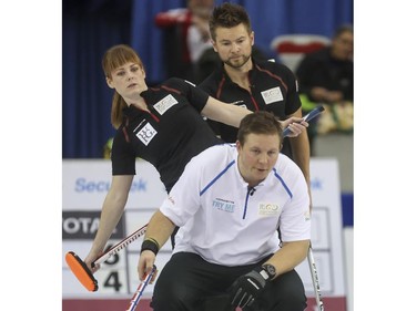 Mike McEwen, back right, and Dawn McEwen watch an incoming shot over the shoulder Team Europe's Christoffer Svae during mixed doubles Continental Cup curling action at the Markin MacPhail Centre in Calgary, on January 10, 2015.