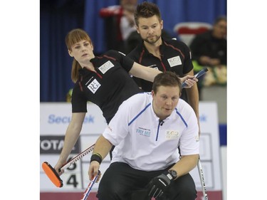 Mike McEwen, back right, and Dawn McEwen watch an incoming shot over the shoulder Team Europe's Christoffer Svae during mixed doubles Continental Cup curling action at the Markin MacPhail Centre in Calgary, on January 10, 2015. Team Europe took this 6-5 nail-biter match.
