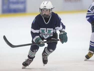 Jackson Ward of the PeeWee league's Midnapore Mavericks skates for the puck during the first day of Esso Minor Hockey Week in Calgary, on January 10, 2015. The 36th annual EMHW will be held at rinks across the city from January 10 to 18, 2014.