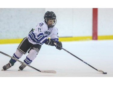 Davis Crump skates with the puck during the first day of the Esso Minor Hockey Week in Calgary, on January 10, 2015. The 36th annual EMHW will be held at rinks across the city from January 10 to 18, 2014.