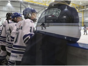 FILE PHOTO: A reflection in glass from the Glenlake Hawks bench shows the Midnapore Mavericks.