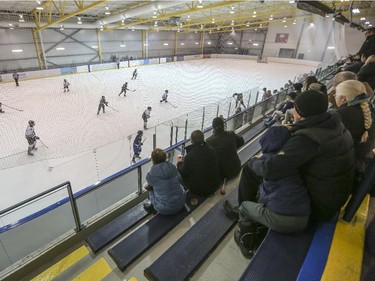 Spectators fill the stands at the Max Bell Centre as the Midnapore Mavericks and the Glenlake Hawks, both of the PeeWee hockey league play on the first day of the Esso Minor Hockey Week in Calgary, on January 10, 2015. The 36th annual EMHW will be held at rinks across the city from January 10 to 18, 2014.