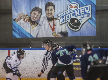 The Midnapore Mavericks Jeffery Maier, centre and the Glenlake Hawks' Wes Birdsell, left, face-off during the first day of Esso Minor Hockey Week in Calgary, on January 10, 2015. The 36th annual EMHW will be held at rinks across the city from January 10 to 18, 2014.