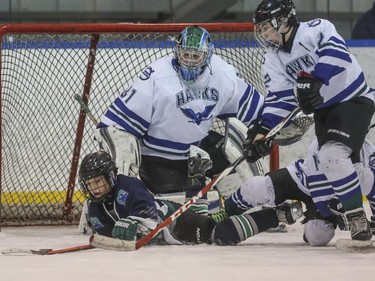 The Midnapore Mavericks of the PeeWee hockey league make a rush at the net during the first day of Esso Minor Hockey Week in Calgary, on January 10, 2015. The 36th annual EMHW will be held at rinks across the city from January 10 to 18, 2014.