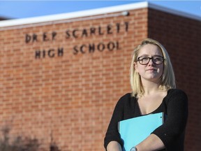 Meaghan Lautischer, a Grade 12 student at Dr. E.P Scarlet High School, poses for a photo in front of her school in Calgary, on January 14, 2015. Lautischer was one of the students impacted by the system error during finals.