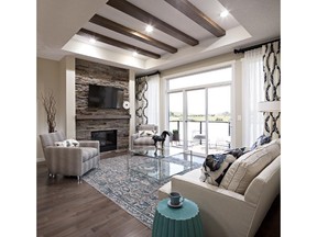 The great room features a stylish tray-style ceiling in a show home at the Shoreline Villas development by GableCraft Homes in Airdrie.