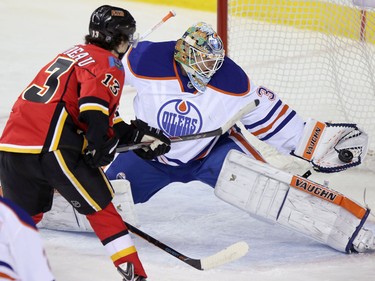 Edmonton Oilers goalie Ben Scrivens stops a shot from Calgary Flames Johnny Gaudreau during their game at the Scotiabank Saddledome  in Calgary on January 30, 2014.