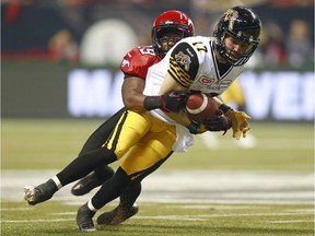 Jamar Wall of the Calgary Stampeders tackles Luke Tasker of the Hamilton Tiger-Cats during the 102nd Grey Cup at BC Place last November.