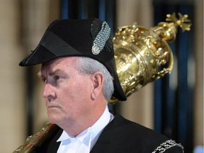 House of Commons Sergeant-at-Arms Kevin Vickers carries the mace on Parliament Hill in Ottawa on Oct. 23, 2014.