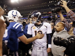 FILE - In this Oct. 20, 2013, file photo, file photo, Denver Broncos quarterback Peyton Manning, right, greets Indianapolis Colts quarterback Andrew Luck (12) after an NFL football game in Indianapolis. (AP Photo/Michael Conroy, File)