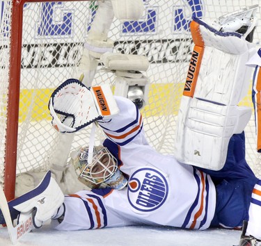 Edmonton Oilers goalie Ben Scrivens blocks a shot on net from Calgary Flames during their game at the Scotiabank Saddledome  in Calgary on January 30, 2014.