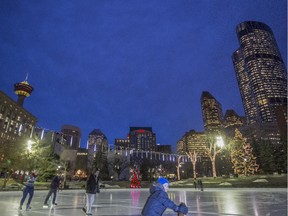 Skaters young and old enjoy a skate at Olympic Plaza surrounded by the warm glow of The Bow, the Calgary Tower and Christmas lights, on a lovely winter evening in Calgary, on December 11, 2014.