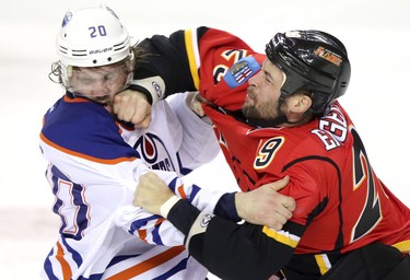 Edmonton Oilers Luke Gazdic, left and Calgary Flames Deryk Engelland fight it out during their game at the Scotiabank Saddledome  in Calgary on January 30, 2014.