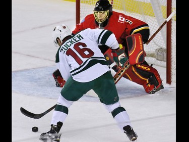 Calgary Flames goaltender Jonas Hiller stopped this scoring chance by the Minnesota Wild's Jason Zucker during the first period of NHL action at the Scotiabank Saddledome on Thursday Jan. 29, 2015.