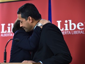 Alberta Liberal Leader Raj Sherman gets a hug from Alberta Liberal Party President Shelley Wark-Martyn after announcing he's resigning his position as leader and will not run in the next election.