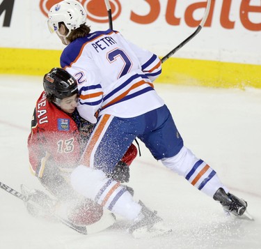 Edmonton Oilers Jeff Petry,right, collides with Calgary Flames Johnny Gaudreau during their game at the Scotiabank Saddledome  in Calgary on January 30, 2014.