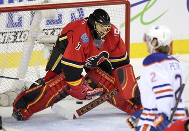 Edmonton Oilers score on Calgary Flames netminder Jonas Hiller during their game at the Scotiabank Saddledome in Calgary on January 30, 2014.