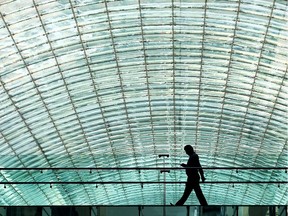 A man walks across a pedestrian walkway at The Core shopping centre in Calgary, Alberta Wednesday, May 16, 2013.