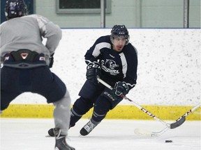 Mount Royal University Cougars centre Tyler Fiddler skates with teammates during practice earlier this week at the Flames Community Arenas. Fiddler, who used to play for the U of C Dinos, will have a unique perspective in Thursday's Crowchild Classic.