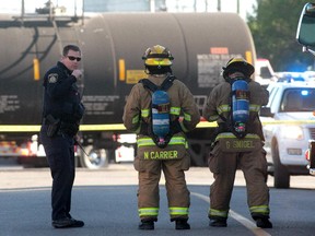 Police and fire personnel block off 15th Street in Inglewood at the scene of a train derailment which forced the evacuation of nearby homes on September 11, 2013.