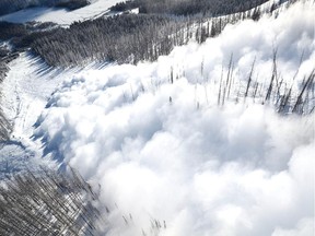 Explosive triggered avalanche above a highway in the mountain parks.