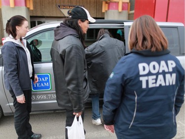 DOAP team outreach worker Chelsea Houston, left, and Jill Kirk help two men and one woman into their van after the three were found intoxicated at Marlborough Mall. The three were taken back to the Alpha House shelter.