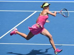 Eugenie Bouchard of Canada hits a return against Irina-Camelia Begu of Romania in their women's singles match on day seven of the 2015 Australian Open tennis tournament in Melbourne on Jan. 25.