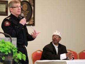Iman Abdi Hersy, right, listens as Calgary Police Chief Rick Hanson speaks with members of the Calgary Somali community at the Abu Bakr Musallah Mosque on Saturday evening January 10, 2015. The meeting was held to help find ways to counter recent violence within the Somali community.