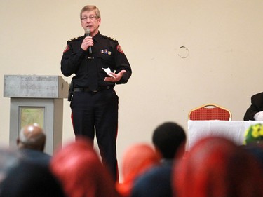 Iman Abdi Hersy, right, listens as Calgary Police Chief Rick Hanson speaks with members of the Calgary Somali community at the Abu Bakr Musallah Mosque on Saturday evening January 10, 2015. The meeting was held to help find ways to counter recent violence within the Somali community.