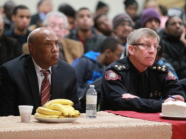 Mohamed Jama, President of the Somali Canadian Society of Calgary,  and Calgary Police Chief Rick Hanson listen during a meeting at the Abu Bakr Musallah Mosque on Saturday evening January 10, 2015. The meeting was held to help find ways to counter recent violence within the Somali community.
(Gavin Young/Calgary Herald)
(For City section story by Erika Stark) Trax# 00061771A