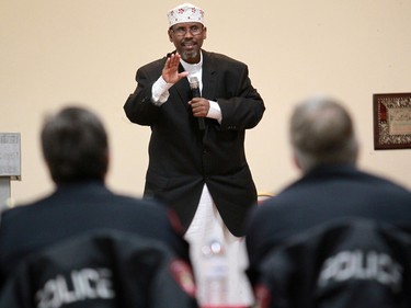 Calgary Police Chief Rick Hanson, right foreground, listens as Iman Abdi Hersy addresses members of the Calgary Somali community at the Abu Bakr Musallah Mosque on Saturday evening January 10, 2015. The meeting was held to help find ways to counter recent violence within the Somali community.