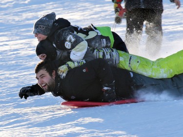 From top, Seth Belzale, Jeremy Switzer and Jamie Harrison, go for a triple decker ride in the fresh snow on the toboggan hill in St. Andrew's Heights on Sunday January 11, 2015.