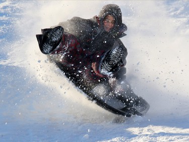 Tobogganers enjoy near perfect conditions in the fresh snow on the hill in St. Andrews Heights on Sunday January 11, 2015.