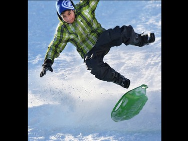 Tariq Saddleback gets some air as he soars over a jump in the fresh snow on the toboggan hill in St. Andrew's Heights on Sunday January 11, 2015.