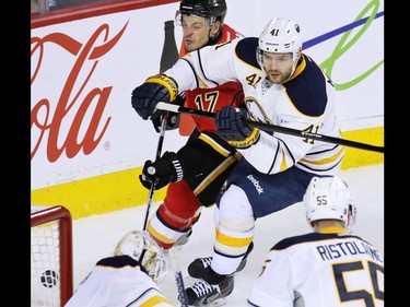 Gavin Young, Calgary Herald
CALGARY, AB: JANUARY 27, 2015 - The Calgary Flames'  Lance Bouma and the Buffalo Sabres' Andrej Meszaros jostle as a shot bounces of the edge of the Sabres' net in NHL action at the Scotiabank Saddledome on Tuesday Jan. 27, 2015.
(Gavin Young/Calgary Herald)
(For Sports section story by Scott Cruikshank) Trax# 00057775A