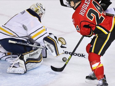 The Calgary Flames'  Jiri Hudler didn't quite catch the rebound as the Buffalo Sabres' Jhonas Enroth reaches to cover the puck in NHL action at the Scotiabank Saddledome on Tuesday Jan. 27, 2015.