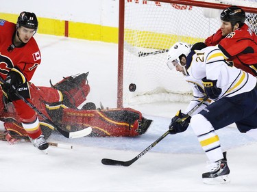 The Calgary Flames' Dennis Wideman, right, helped stop this scoring chance by Buffalo Sabres winger Drew Stafford during the first period of NHL action at the Scotiabank Saddledome on Tuesday Jan. 27, 2015.
(Gavin Young/Calgary Herald)
