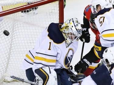 The Calgary Flames' Johnny Gaudreau scores on Buffalo Sabres goaltender Jhonas Enroth during the first period of NHL action at the Scotiabank Saddledome on Tuesday Jan. 27, 2015.
(Gavin Young/Calgary Herald)
(For Sports section story by Scott Cruikshank) Trax# 00057775A