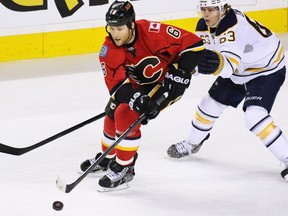 The Calgary Flames' Dennis Wideman is chased by the Buffalo Sabres' Tyler Ennis during the second period of NHL action at the Scotiabank Saddledome on Tuesday Jan. 27, 2015.