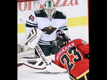 Calgary Flames forward Sean Monahan sends a shot into Minnesota Wild goaltender Devan Dubnyk during the first period of NHL action at the Scotiabank Saddledome on Thursday Jan. 29, 2015.